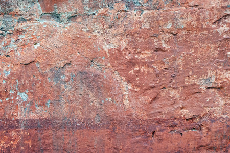 Background of a ocher natural stone wallの写真素材