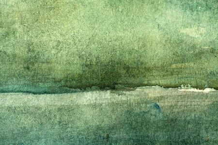 great green watercolor background - paints on a rough texture paperの写真素材
