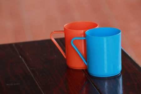 There are the plastic mugs are on the tableの写真素材