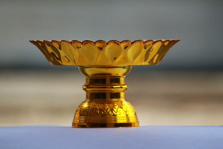 The tray with pedestal.It has gold colour.