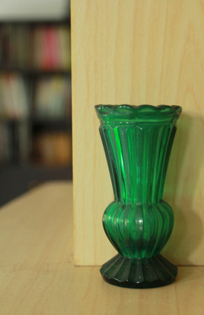 This is a green glass vase on the table.Old but still beautiful.の写真素材
