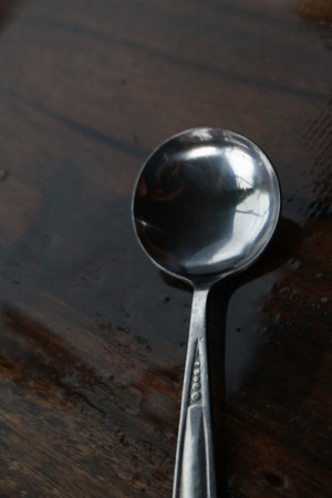 The ball spoon is on the wet table after raining.の写真素材