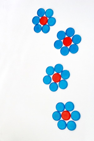 The red and blue circle plastic pieces are arrange  in the shape of flowers.の写真素材