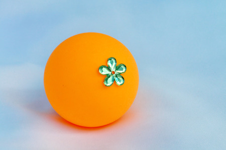 The orange ball decorate by plastic flower.Invent it be a toy for children.の写真素材