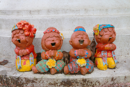 The sculptur of children laugh is the traditional art decoration which can found every where.の写真素材