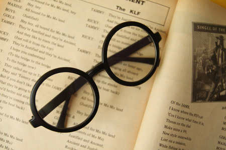 Eyeglasses on the old opening  book.のeditorial素材