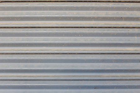 The steel rolling shutter with dust.