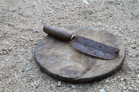 Antique peeler on the wooden chopping block.の写真素材