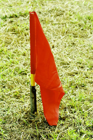 red flag stick on grassland.の写真素材