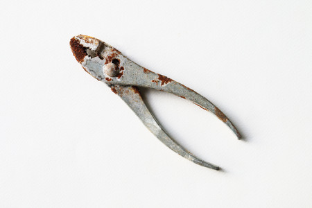 rusty steel pliers on white background.の写真素材