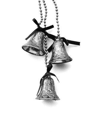 three gold christmas bells are hanging.の写真素材