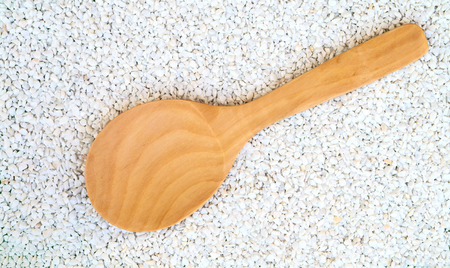 wooden ladle on the white sandの写真素材