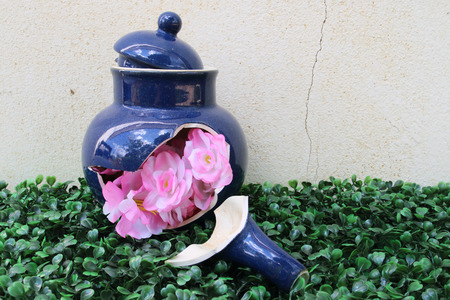 artificial flowers in the broken tea pot for home decorationの写真素材