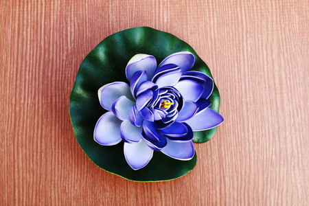 purple artificial lotus on wooden backgroundの写真素材
