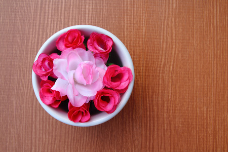 artificial roses in bowl for decoration table.の写真素材