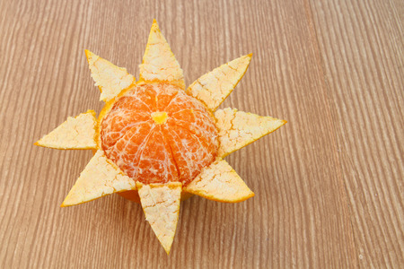 the half peeled orange on wooden backgroundの写真素材
