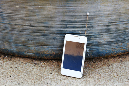 crack mobile  lean against  at the water tankの写真素材