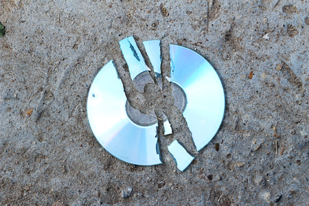 crack compact disc on the concrete floor