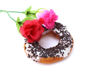 dougnut with chocolate topping decoration with artificial roseの写真素材