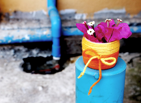 vase made from wool and pink paper flowers decoration with pipe backgroundの写真素材