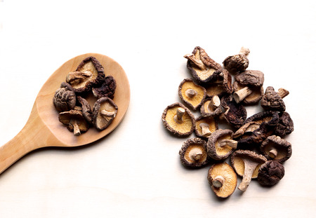 dry chinese mushroom in the spoon and wooden plateの写真素材