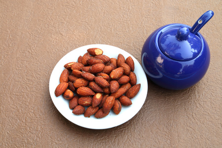 almond with salt in white plate and salt potの写真素材