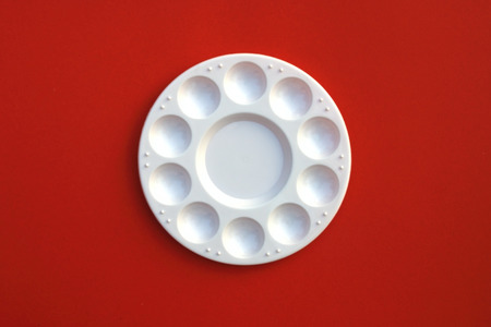 image of round watercolor palette on red backgroundの写真素材