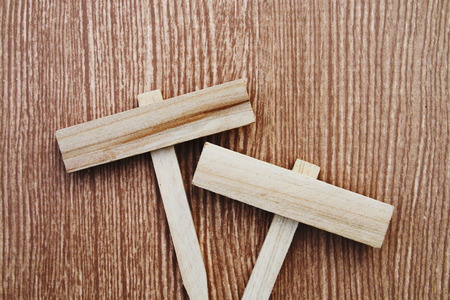 square wooden tags are on wooden background in vintage toneの写真素材