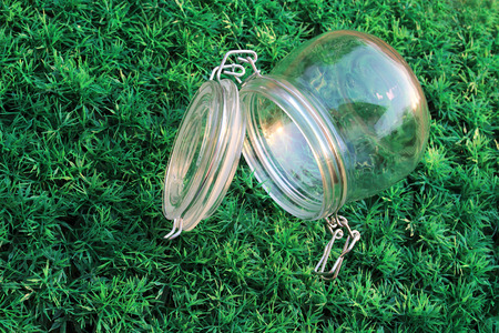 glass container is ope the cover rolling on turfの写真素材