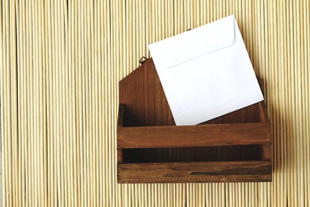 image of small letter box and white envelope on bamboo mattの写真素材