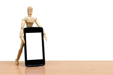 puppet doll holding mobile phone ,isolate white backgroundの写真素材