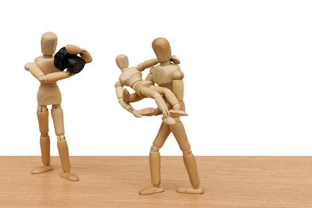 puppet doll take a photo to puppet doll carrying the child ,isolate white backgroundの写真素材