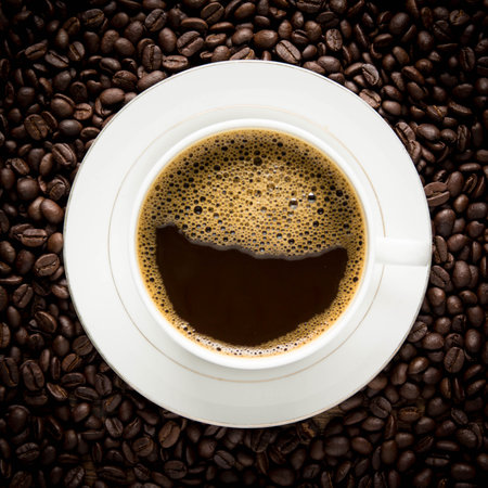 Coffee cup and coffee beans on a dark background, top viewの写真素材