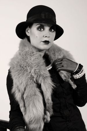 Retro styled fashion portrait of a young woman. Clothing and make-up in twenties style.
