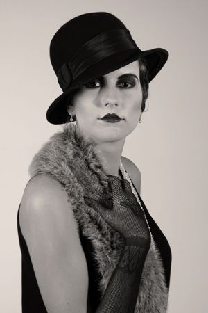   Retro styled fashion portrait of a young woman. Clothing and make-up in twenties style.の写真素材