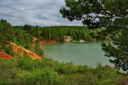 Russia. The South Of Western Siberia. Flooded quarry for copper mining, the increased content of which in the water gives it a blue-green colorの写真素材