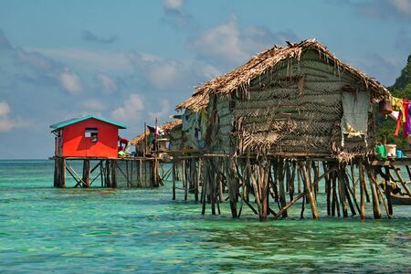 East Malaysia. island of Borneo. 2018/11/29. Sea Gypsies relax after a night of fishing in a fishing village, whose huts are built on wooden stilts.のeditorial素材