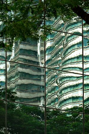Malaysia. Mirror reflection of the capital of Kuala Lumpur, built of glass and concrete.