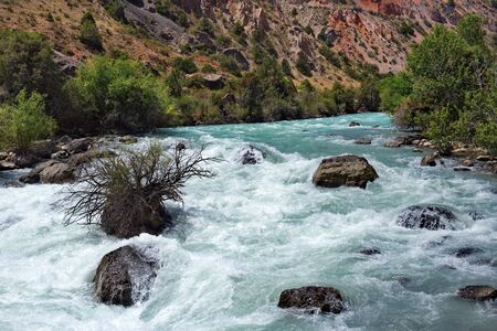 Tajikistan. The Pamir highway. Panorama of the mountain river Iskanderdarya flowing from lake Iskanderkul.の写真素材