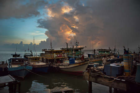 SANDAKAN. MALAYSIA. November 26, 2018. Small fishing vessels are moored at the pier of the fish market, waiting for the sale of fresh catch of sea fish.のeditorial素材