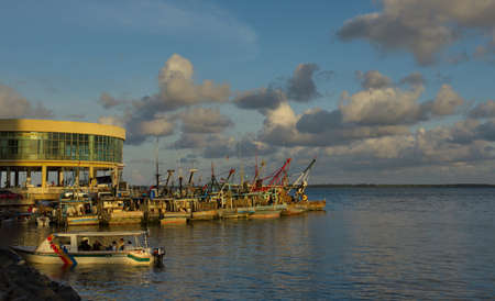 SANDAKAN. MALAYSIA. November 26, 2018. Small fishing vessels are moored at the pier of the fish market, waiting for the sale of fresh catch of sea fish.のeditorial素材
