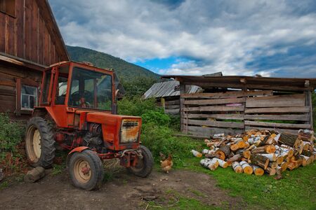 Russia. South Of Western Siberia, Mountain Altai. Tractors on a plot of land in a village on the shore of lake Teletskoye.の写真素材