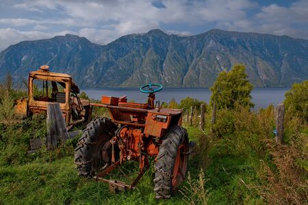 Russia. South Of Western Siberia, Mountain Altai. Tractors on a plot of land in a village on the shore of lake Teletskoye.の写真素材