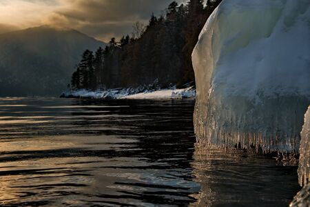 Russia. Mountain Altai. Winter sunset on lake Teletskoye.