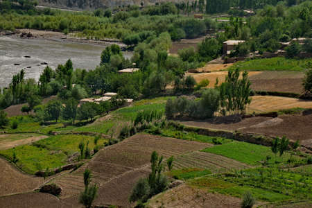 Afghanistan. The Pamir highway. Cultivated stony land on the left bank of the border river Panj.