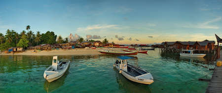 Semporna. Malaysia. December 03, 2018. In the early warm morning, moored on the sandy beach,...