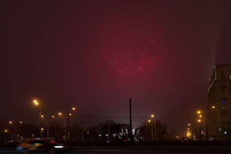 Moscow. Russia. December 20, 2020. Festive fireworks on Kutuzovsky Prospekt near Victory Park in a foggy cold evening.のeditorial素材