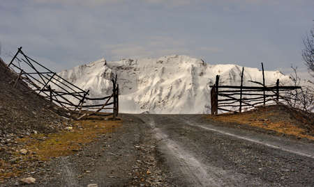 Russia. Republic of Dagestan. Entrance through a wooden gate to a high-altitude pasture near the...