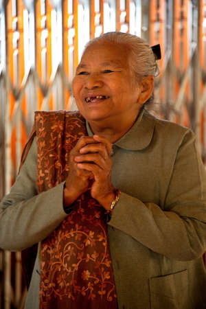 Mandalay. Myanmar. November 22, 2016. An elderly emotional woman is happy to receive guests of a...