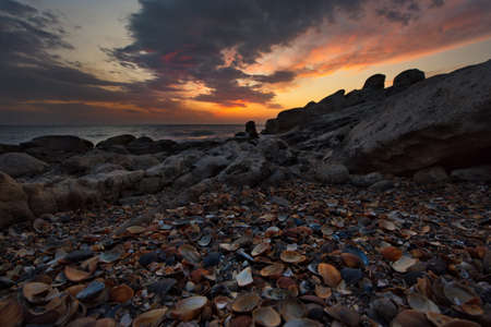 Russia. Dagestan. Dawn on the seashell-strewn rocky shore of the Caspian Sea near the city...